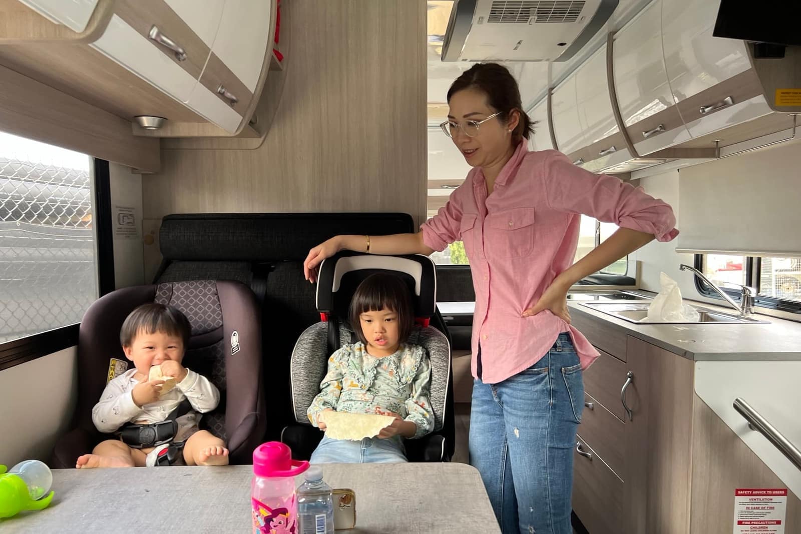 Vanessa and the children inside the camper van