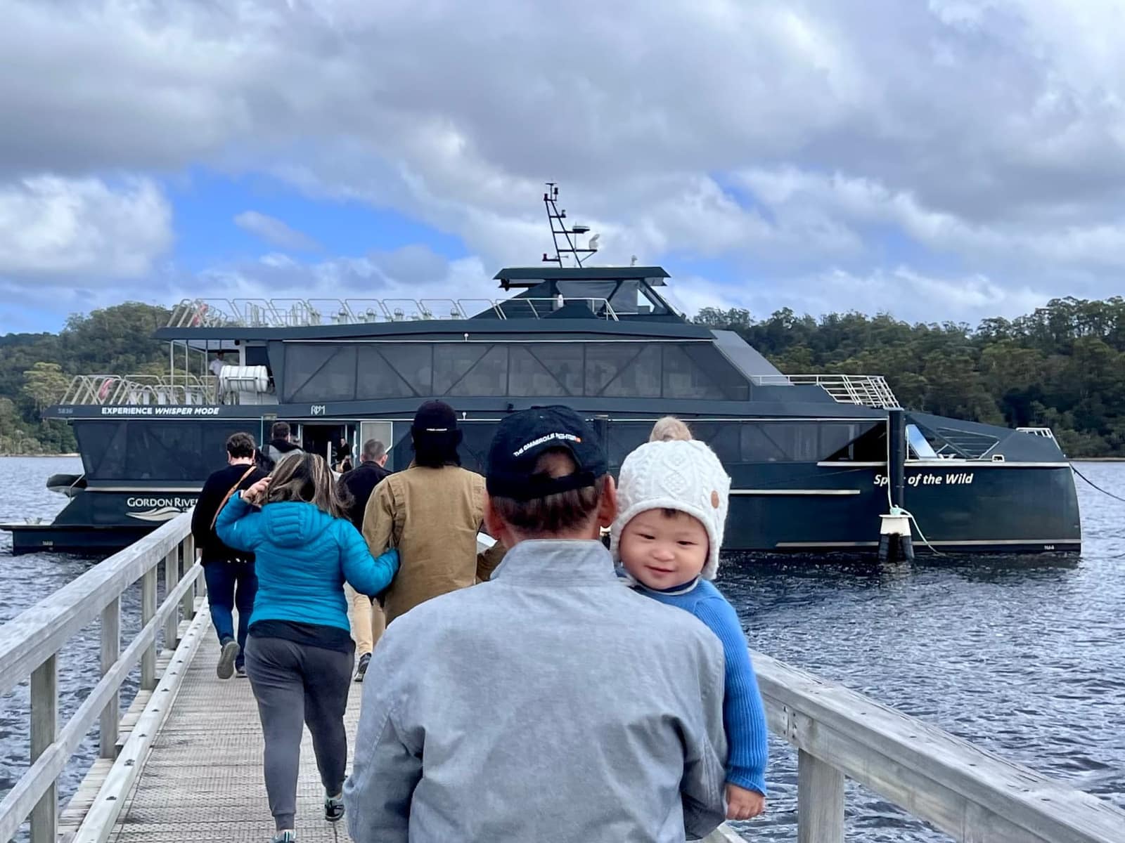 George looking back from the Gordon River boat while being carried by his grandfather