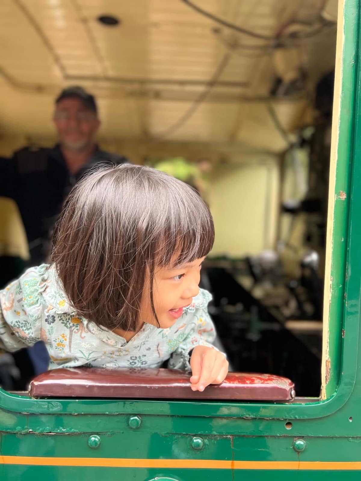 Sophie with the train driver at the front of the railway