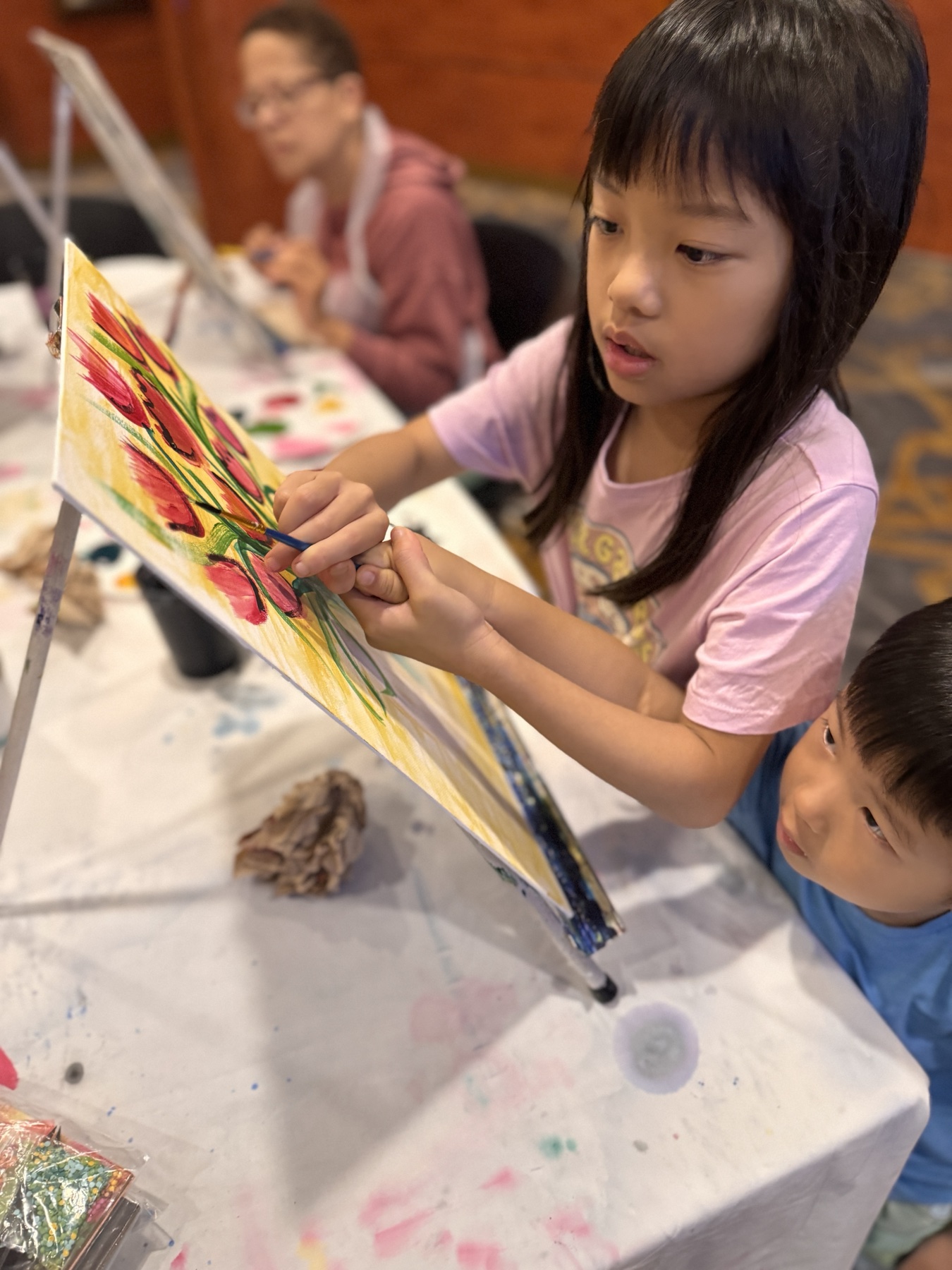 The children doing arts and crafts on board