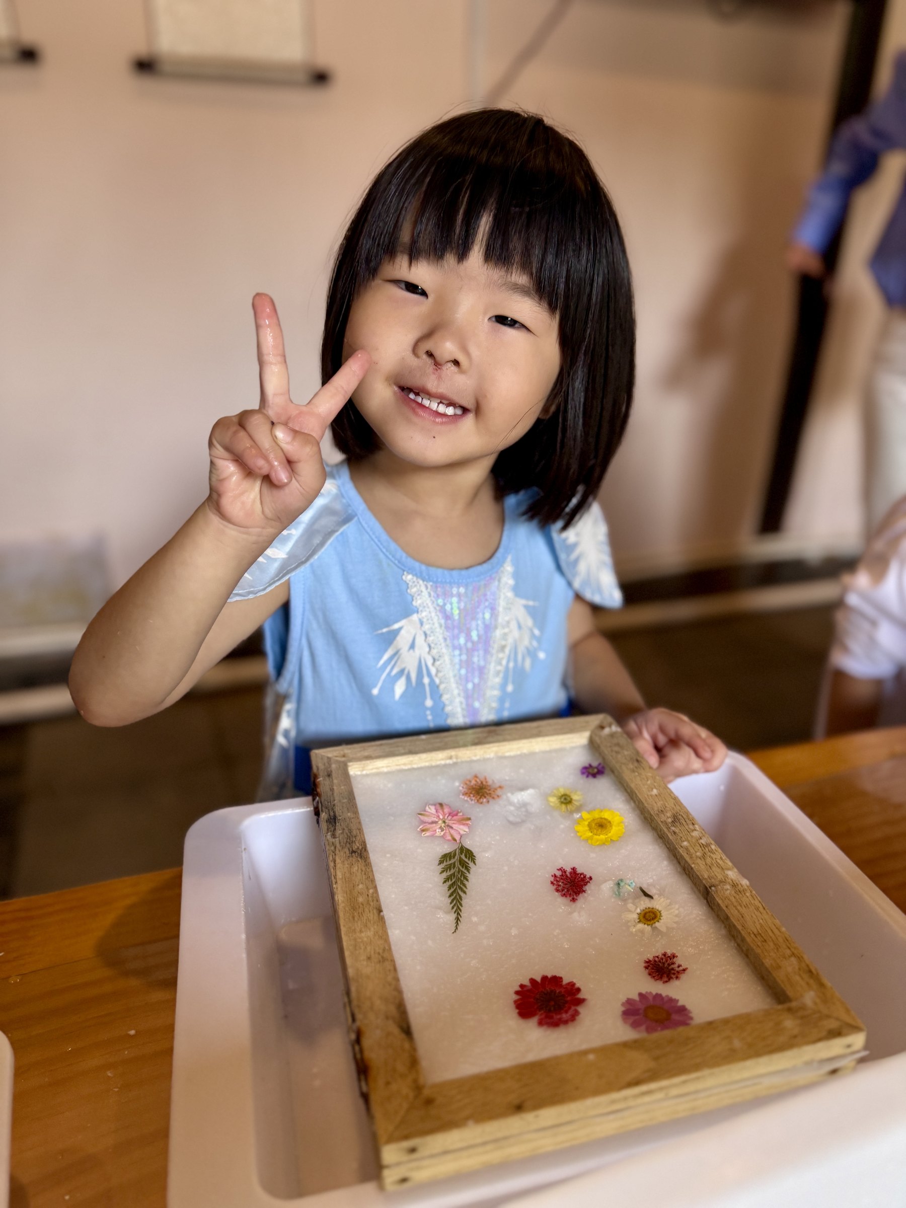 Claire holding her flower craft in Gubei