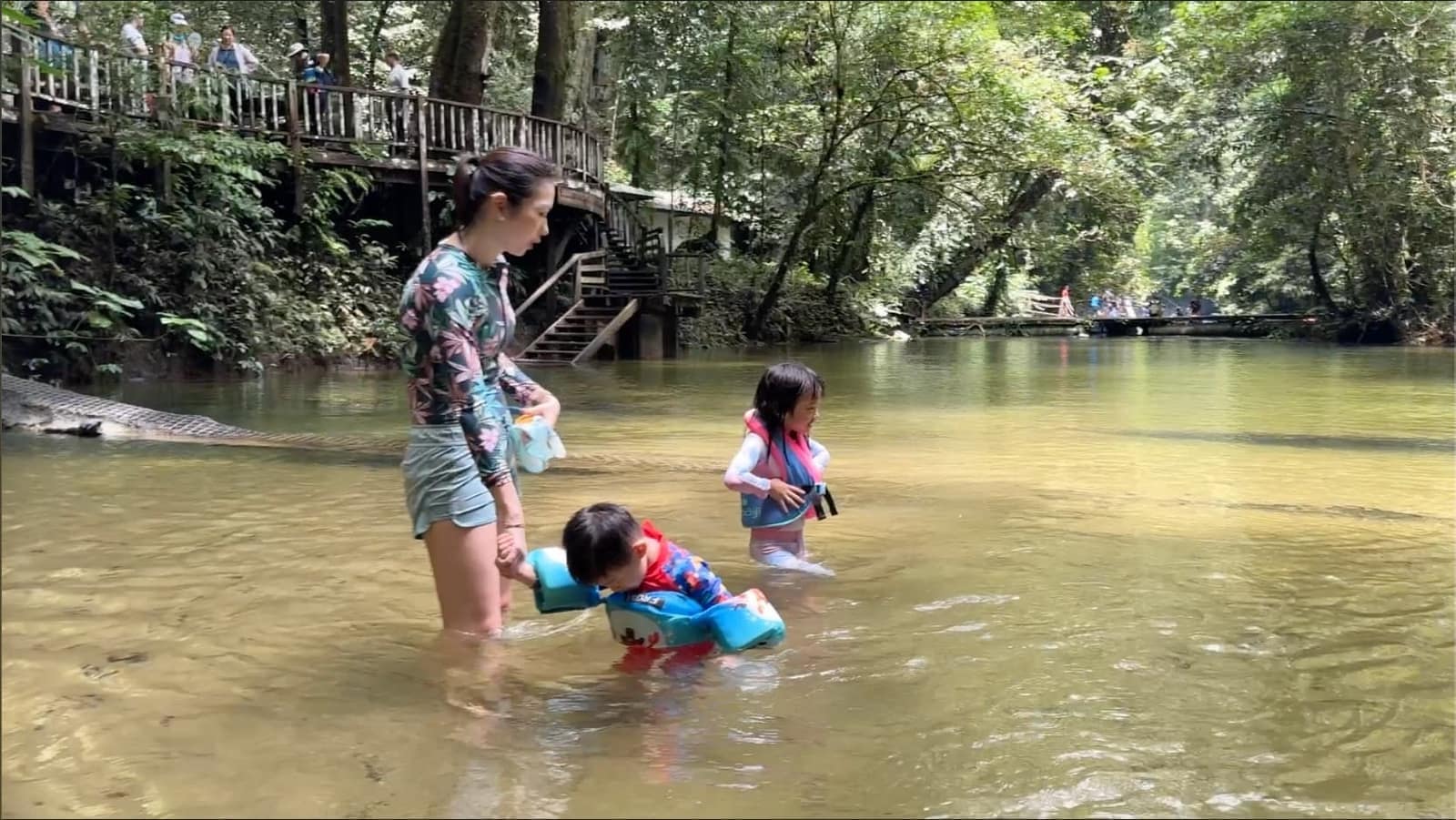 Vanessa, Sophie and George swimming in the natural river beside Clearwater Cave