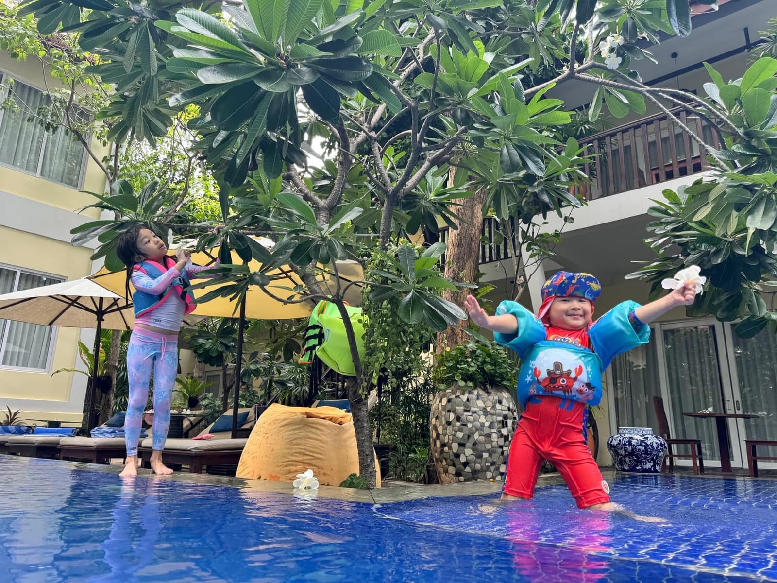 Sophie and George playing beside the pool after arriving in Siem Reap