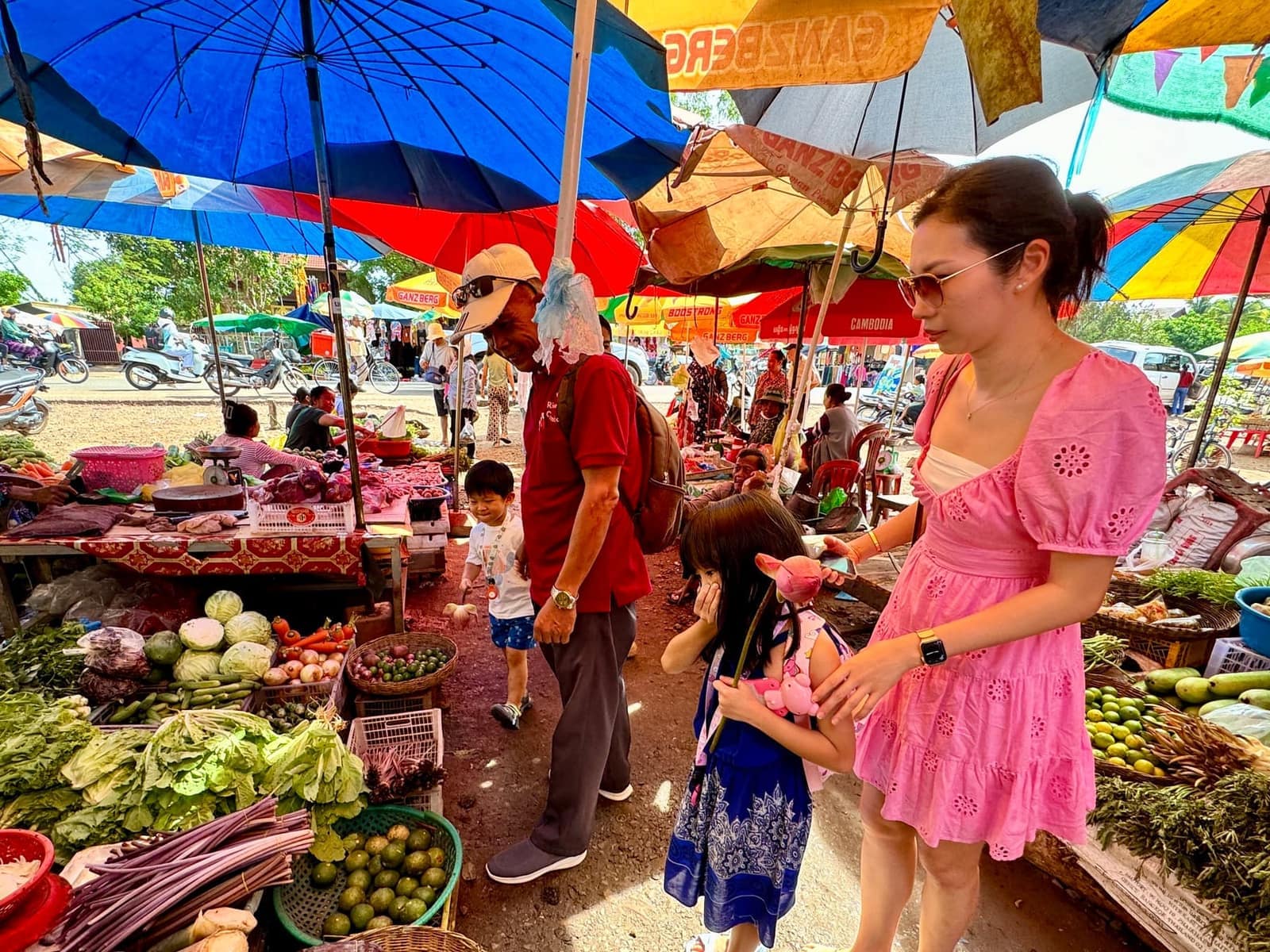 The family walking through a local produce market outside Siem Reap
