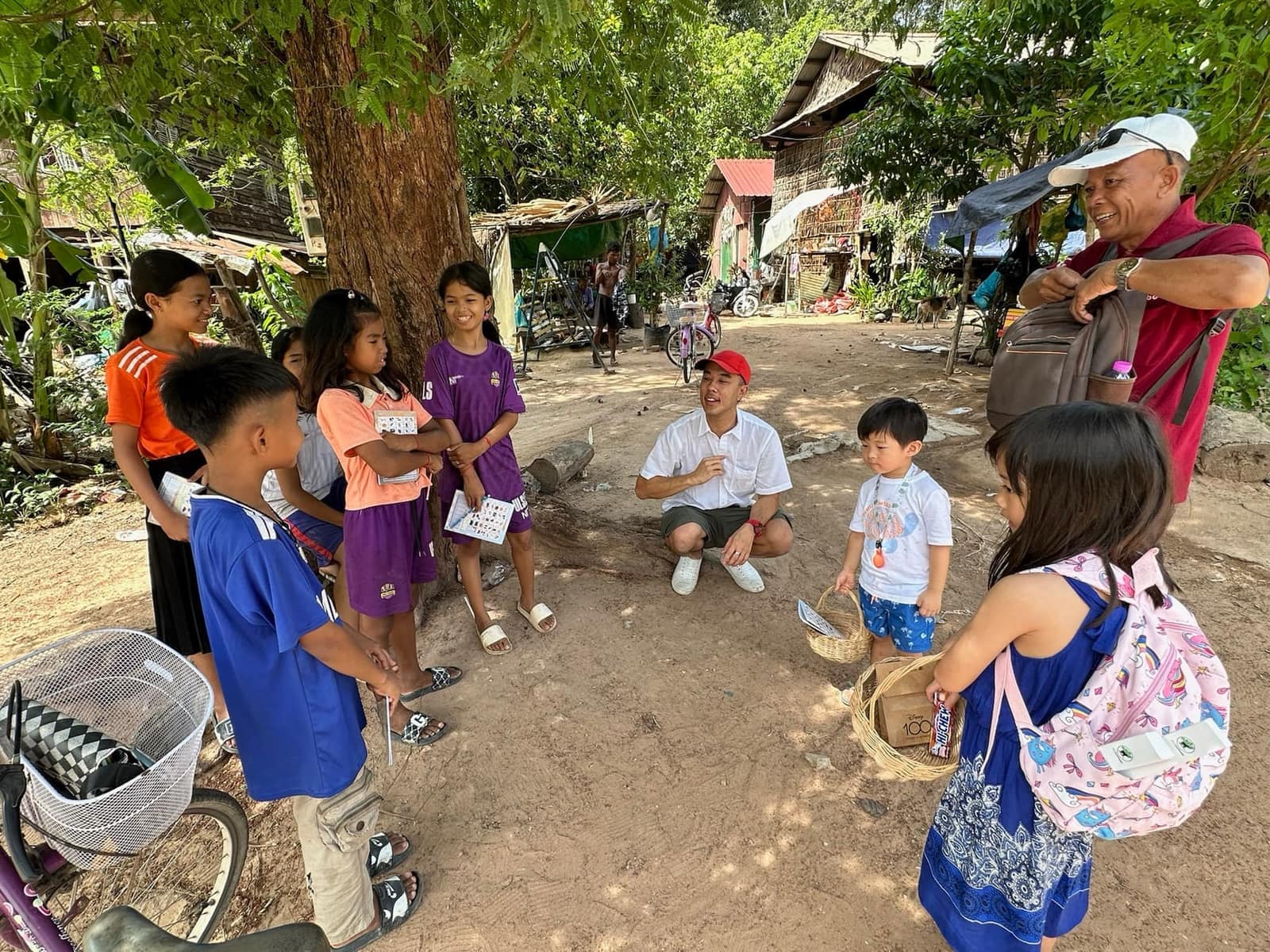 Philip, Sophie and George meeting local children during the village visit