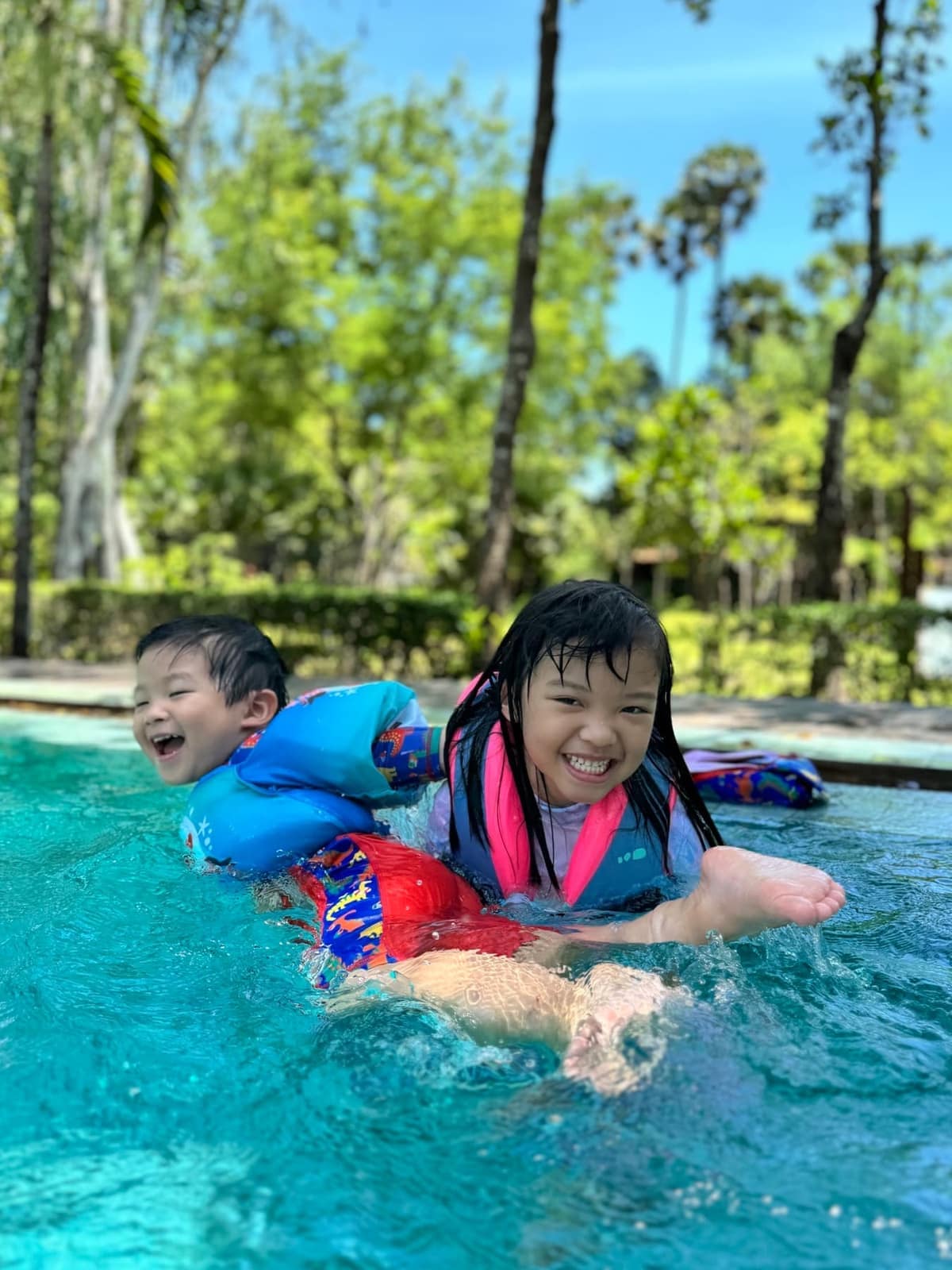 Sophie and George laughing together in the hotel pool