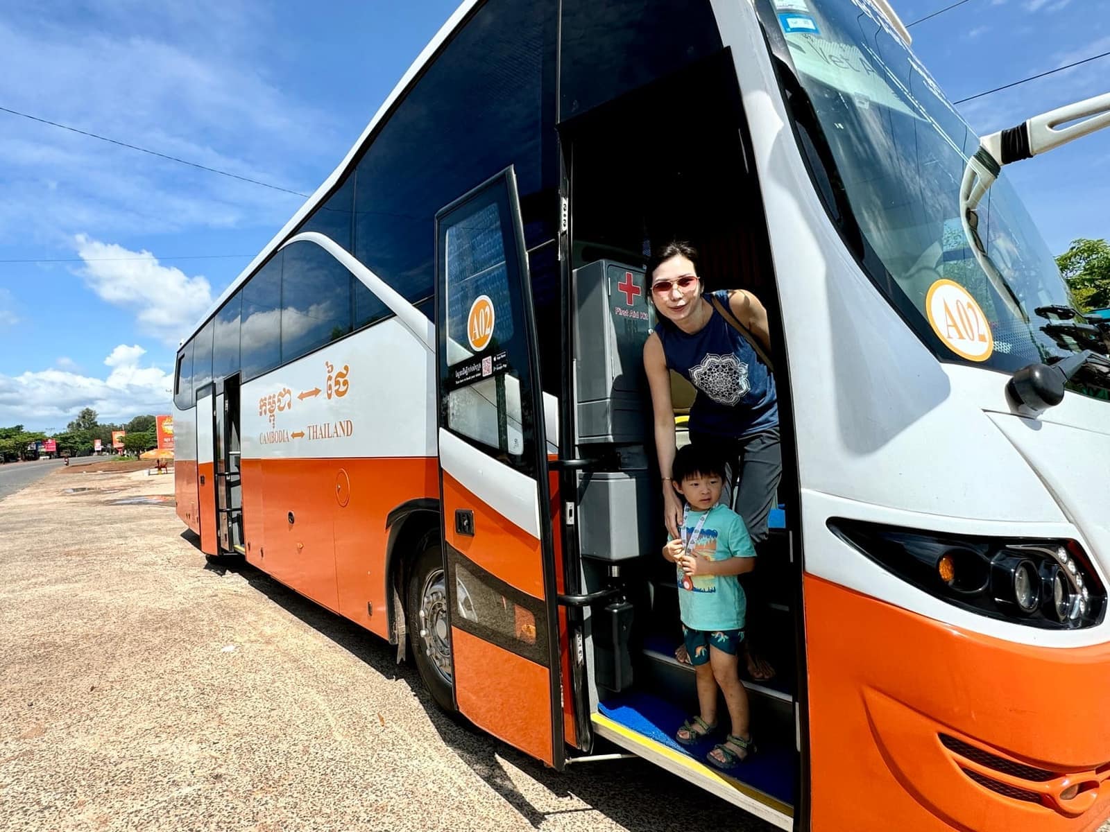 Vanessa and George standing at the door of the bus from Siem Reap to Phnom Penh