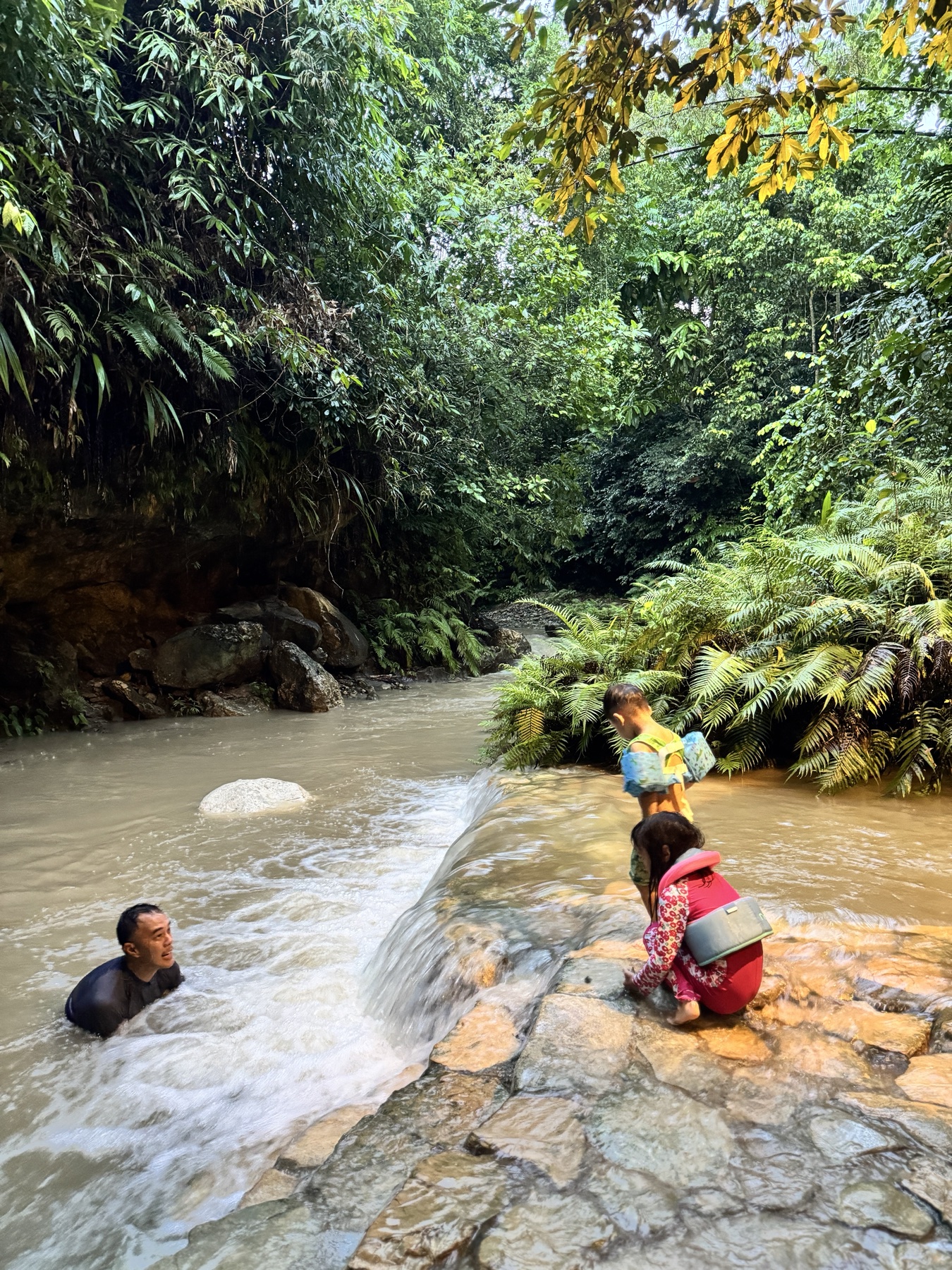 Philip, Sophie and George playing in the stream below the house
