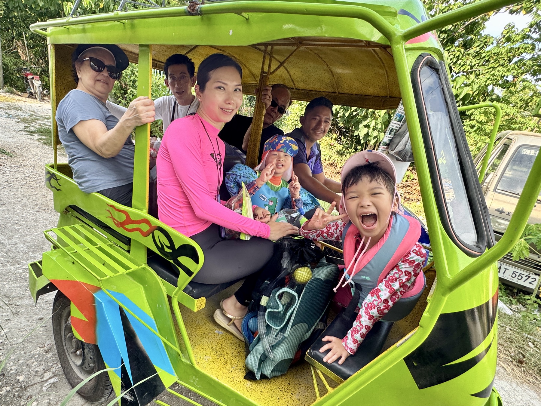 The family crowded into a bright green jeepney on the way to the water