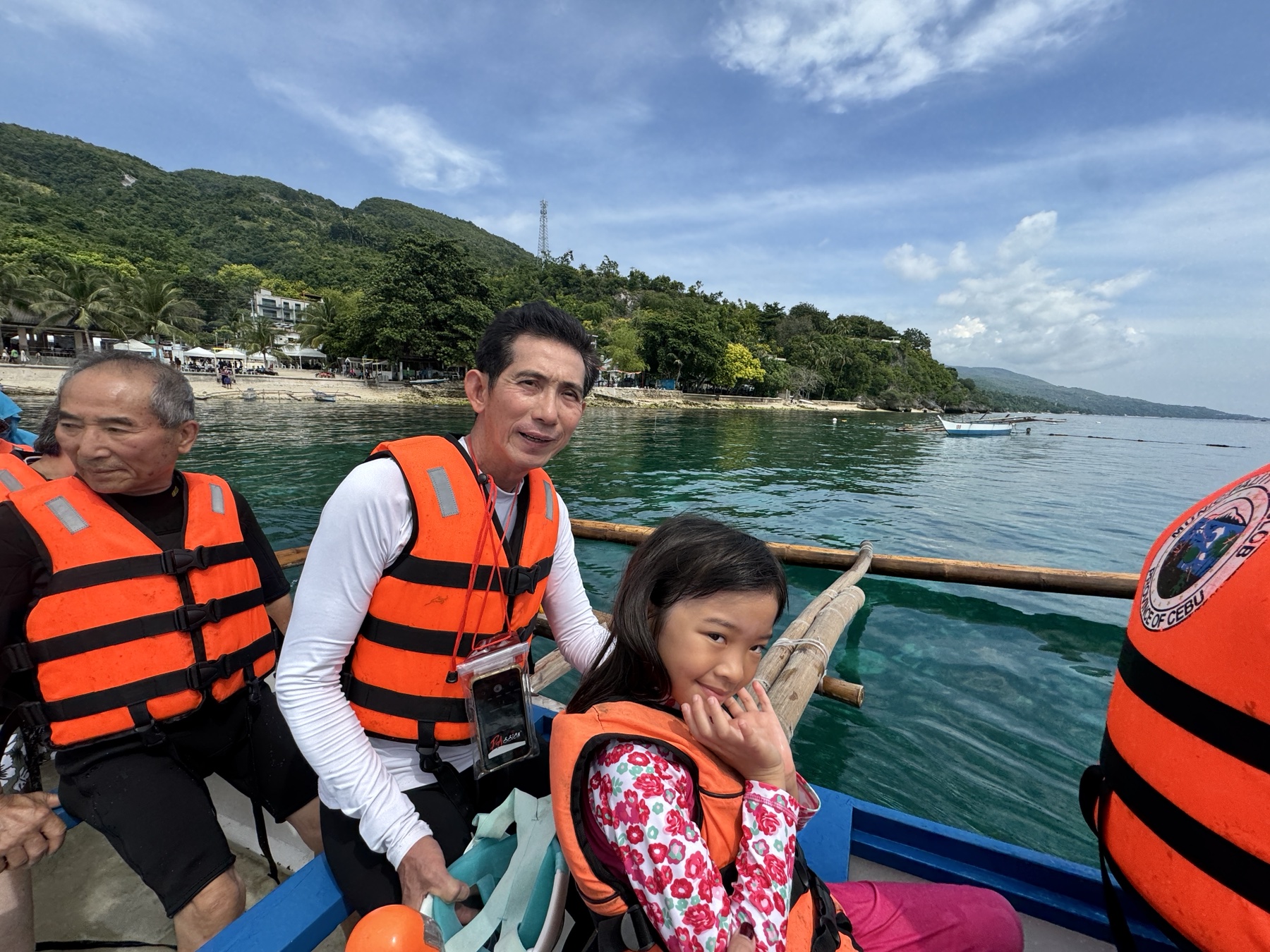 Sophie and the family aboard the small boat from Oslob