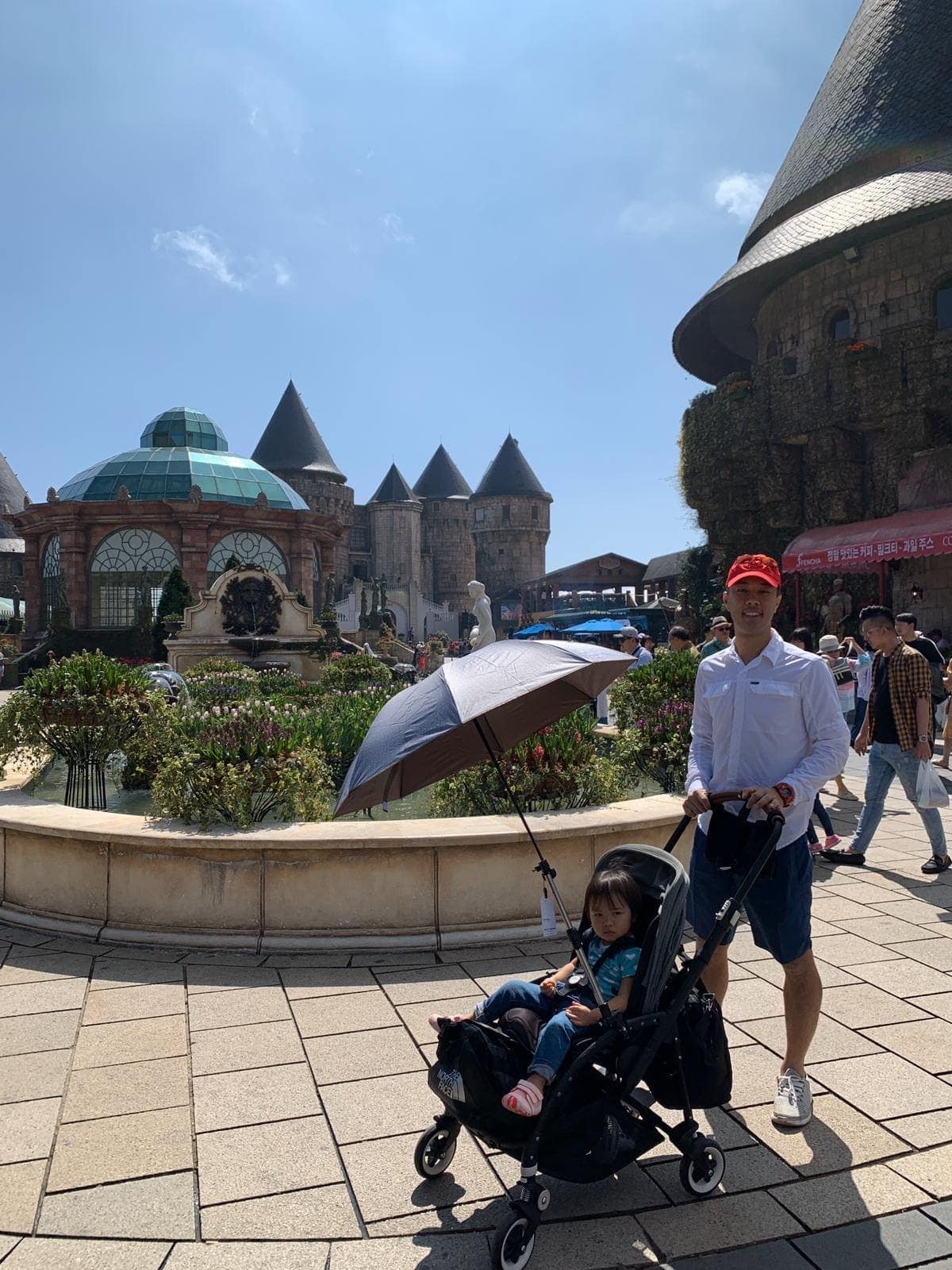 Philip pushing Sophie through the gardens and stone buildings at Ba Na Hills