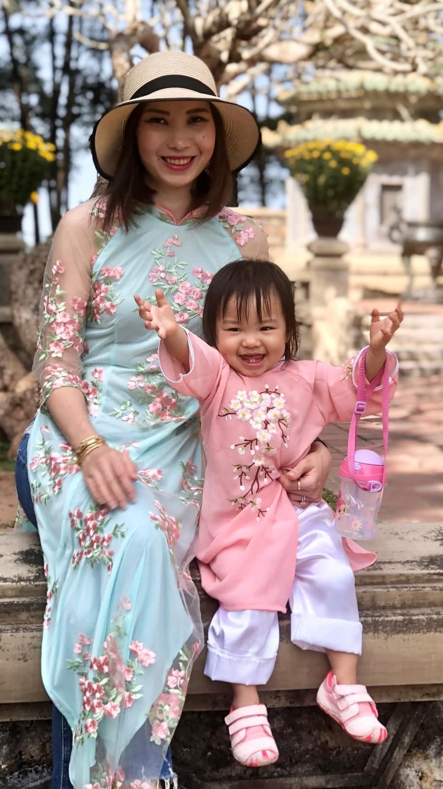 Vanessa and Sophie wearing áo dài together in a garden