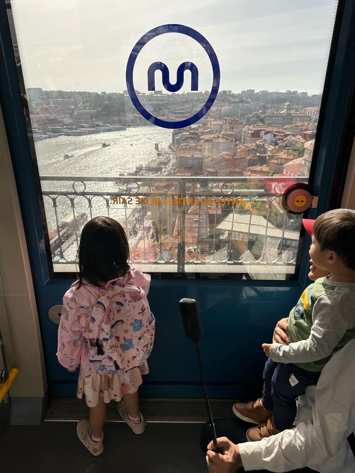 The children riding a public train across Porto