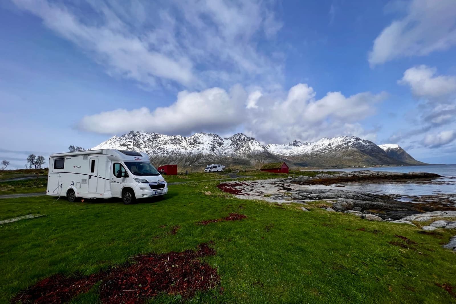 The motorhome below snow-covered mountains in Lofoten