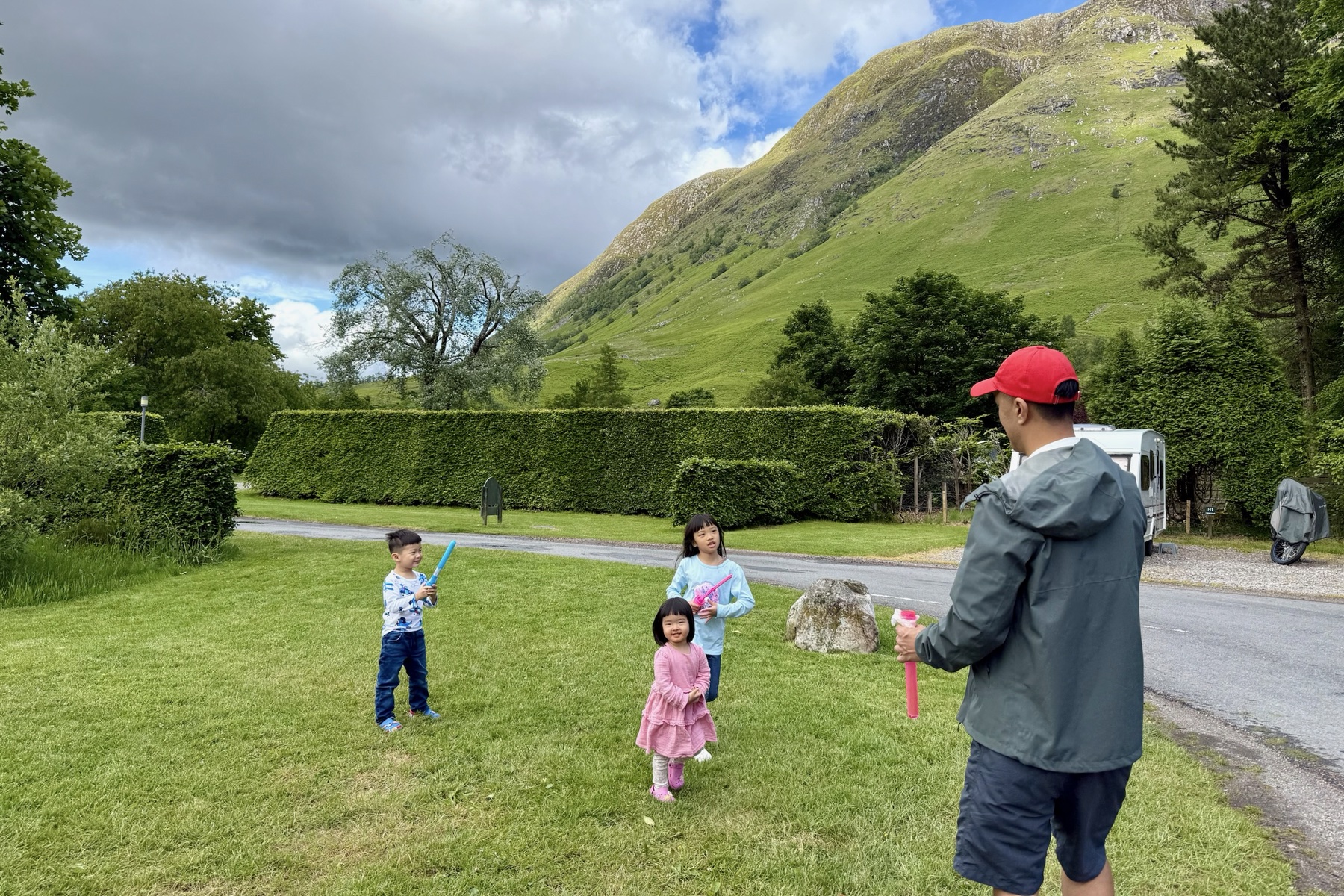 The children playing with bubbles beneath the Glencoe mountains