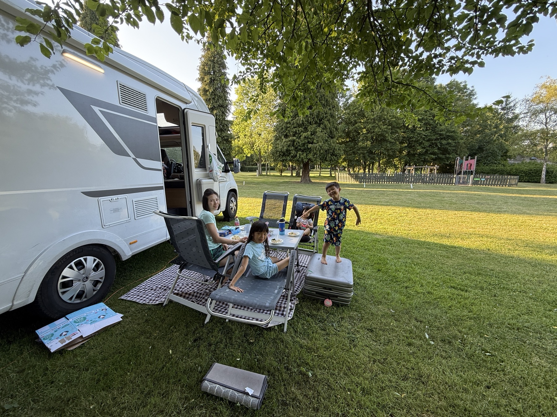 Family dinner at a grassy motorhome campsite