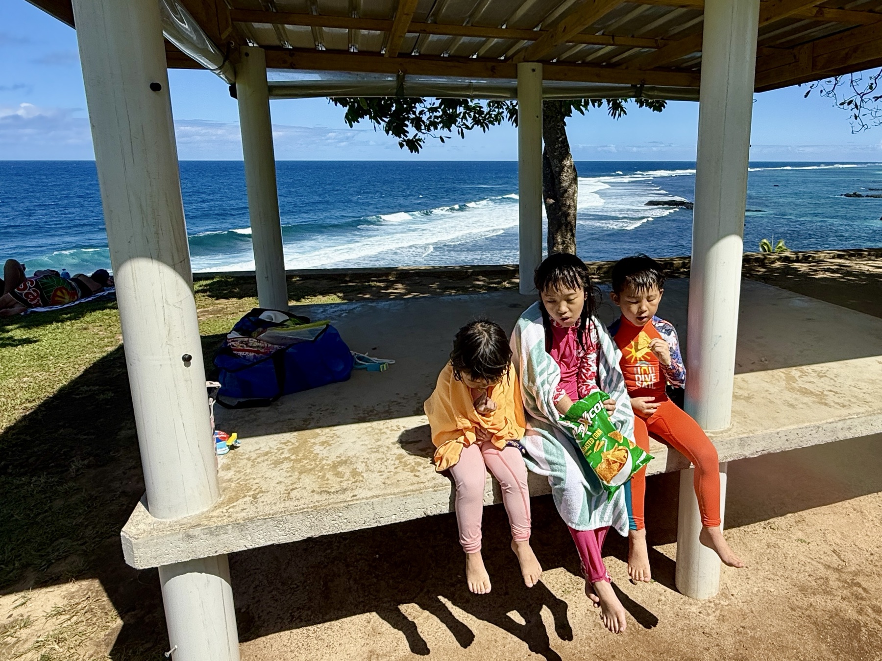 Children resting with snacks after the climb from To-Sua