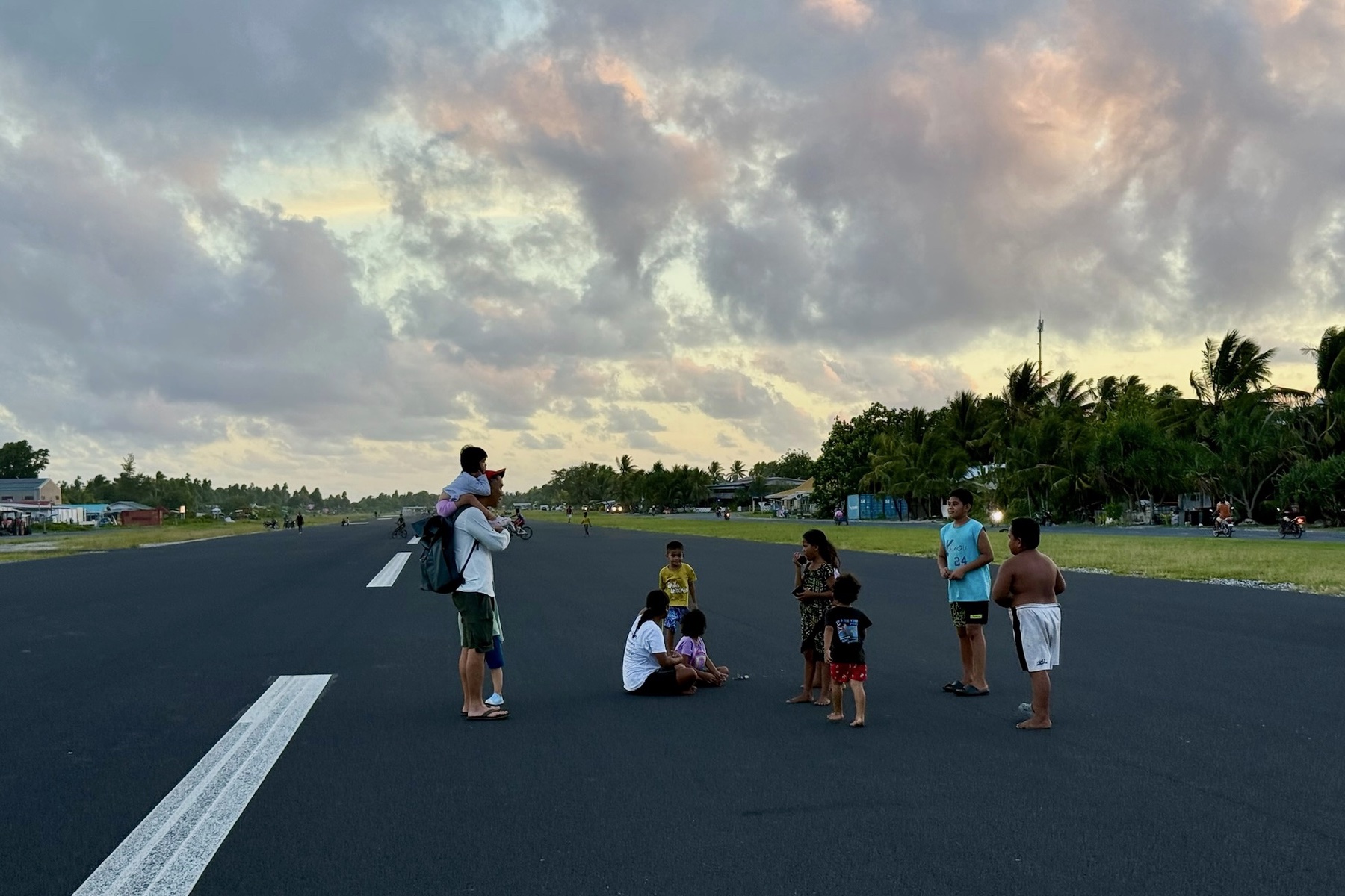 Family talking with local children on Funafuti runway