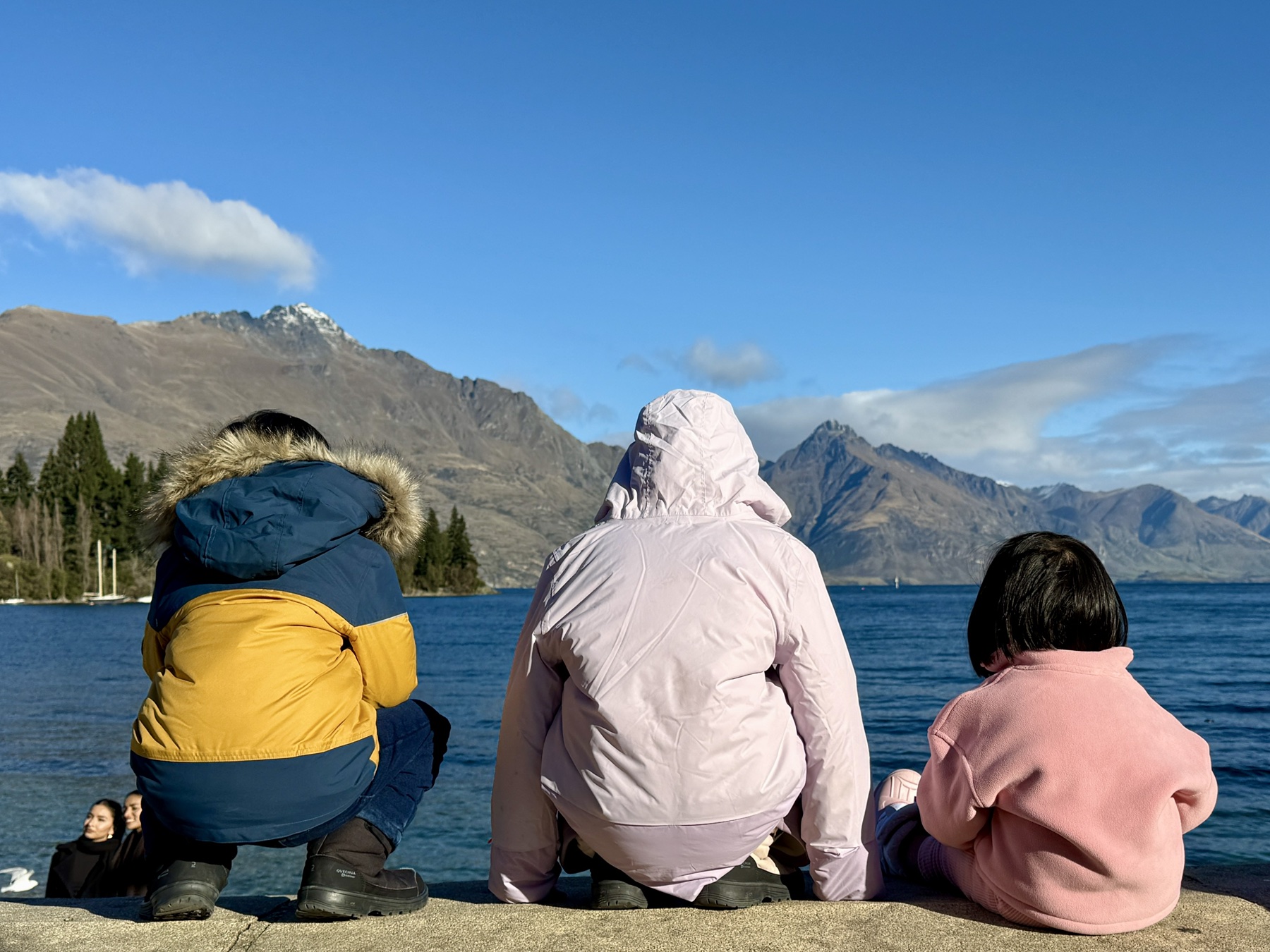 Children looking over Queenstown’s lake and mountains