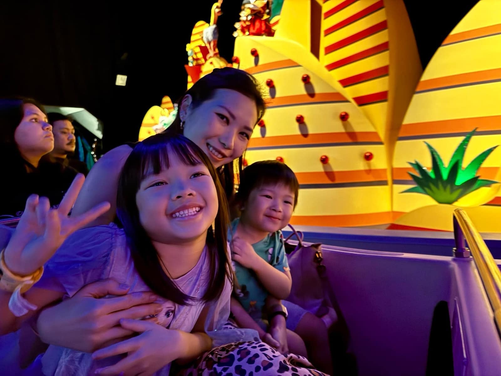 Vanessa and the children riding together at Hong Kong Disneyland