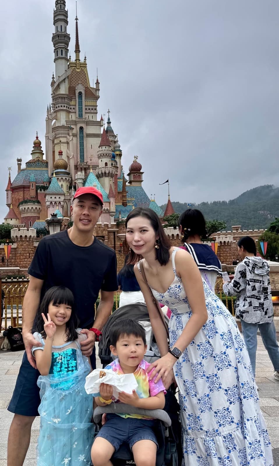 The family together in front of the Castle of Magical Dreams at Hong Kong Disneyland