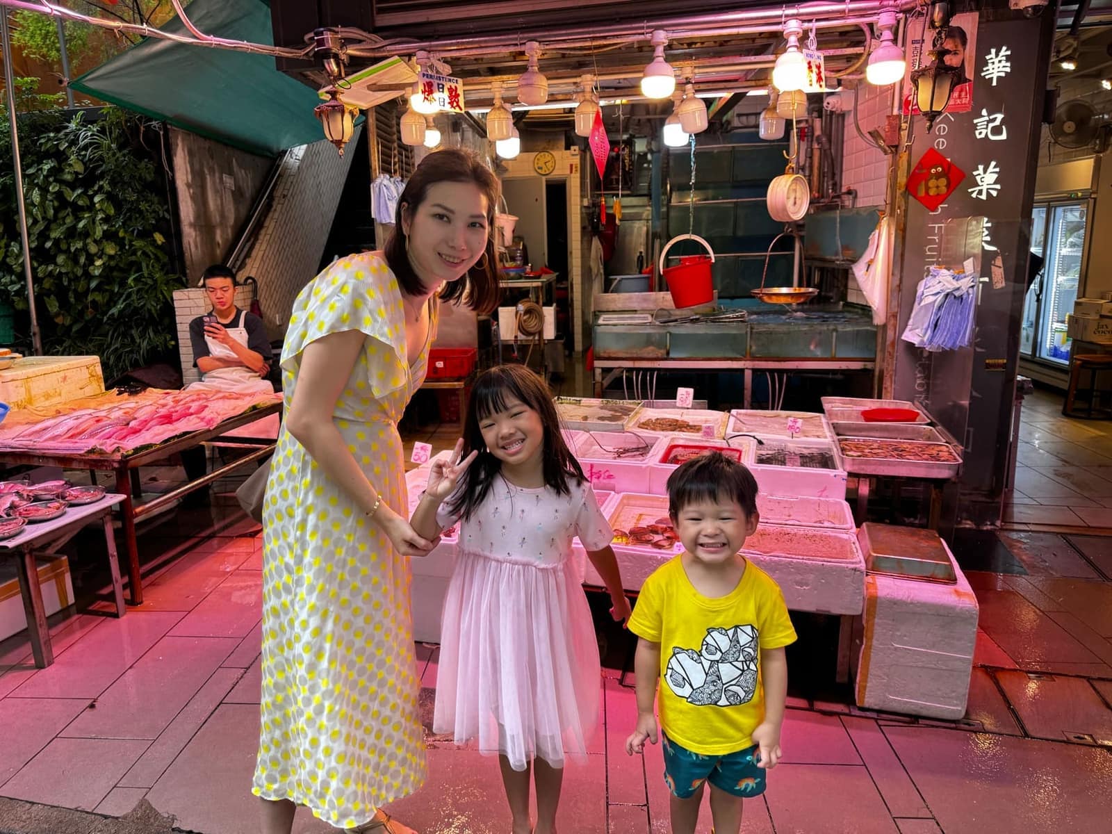 Vanessa and the children outside a street food stall in Hong Kong