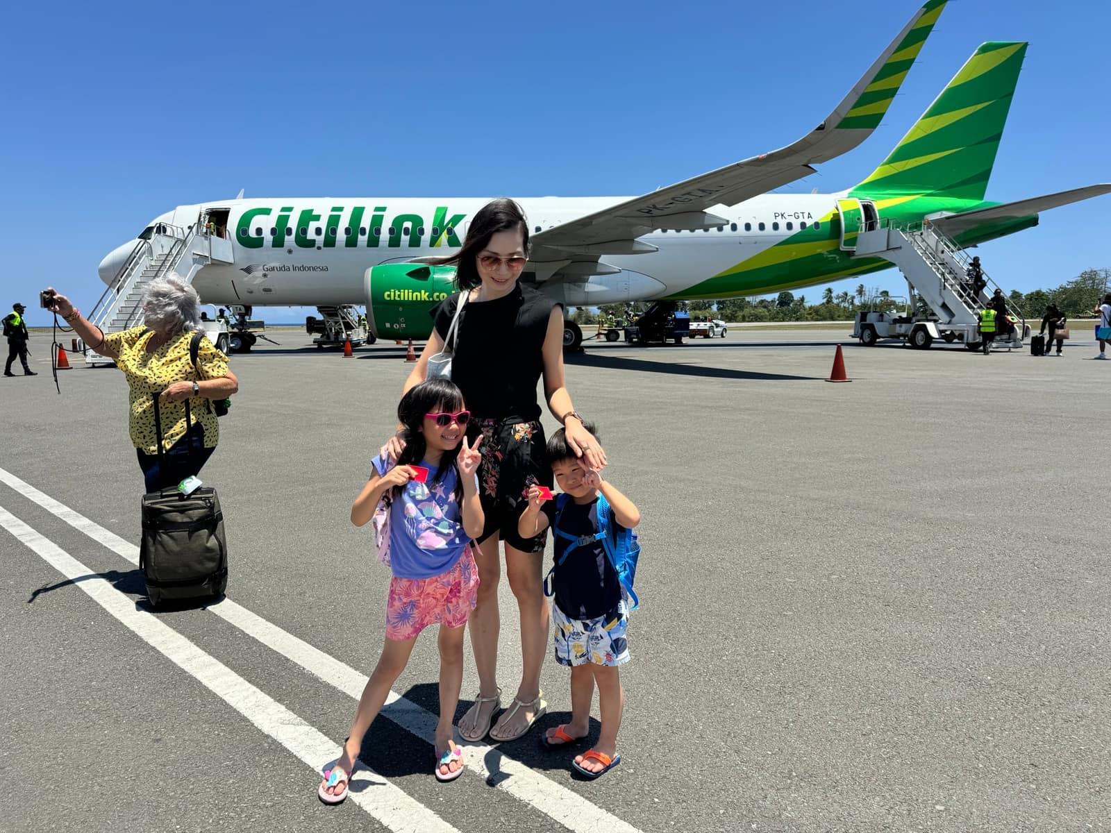 Vanessa and the children beside the aircraft after arriving in Dili