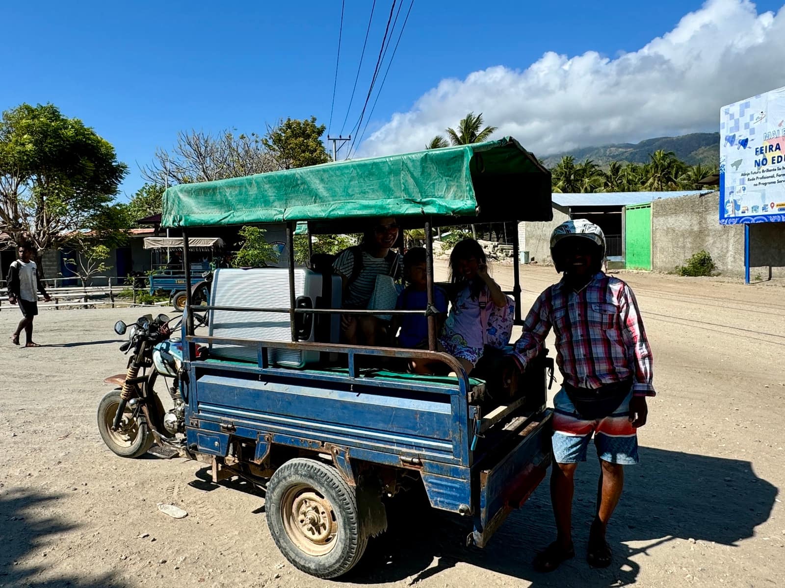 The family boarding a local vehicle after reaching Atauro Island