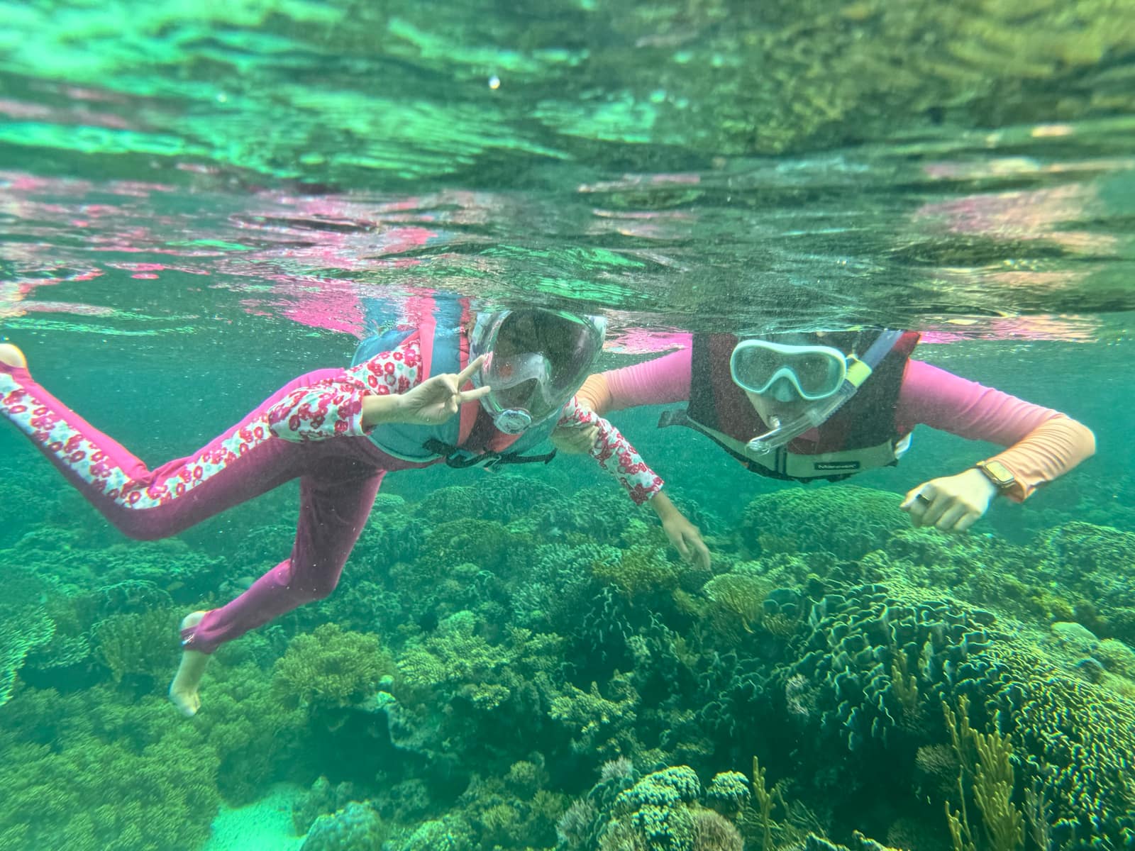 Sophie and Vanessa snorkelling together above the coral reef off Atauro Island