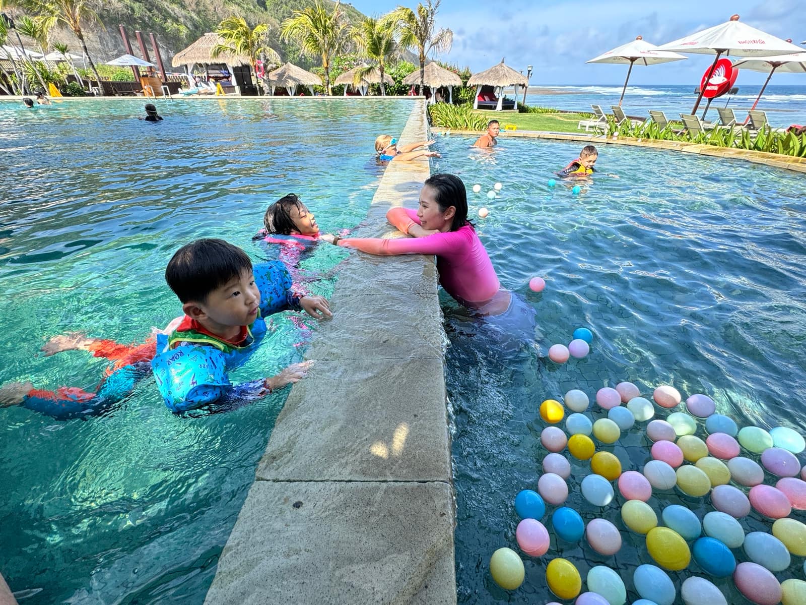 The children playing together in the hotel pool in Bali