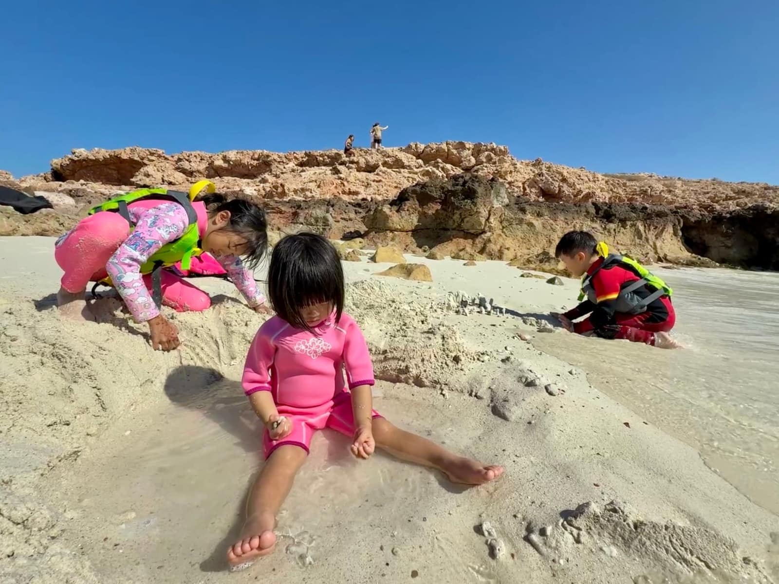 Claire, Sophie and George playing in the shallow water and sand on a Daymaniyat island