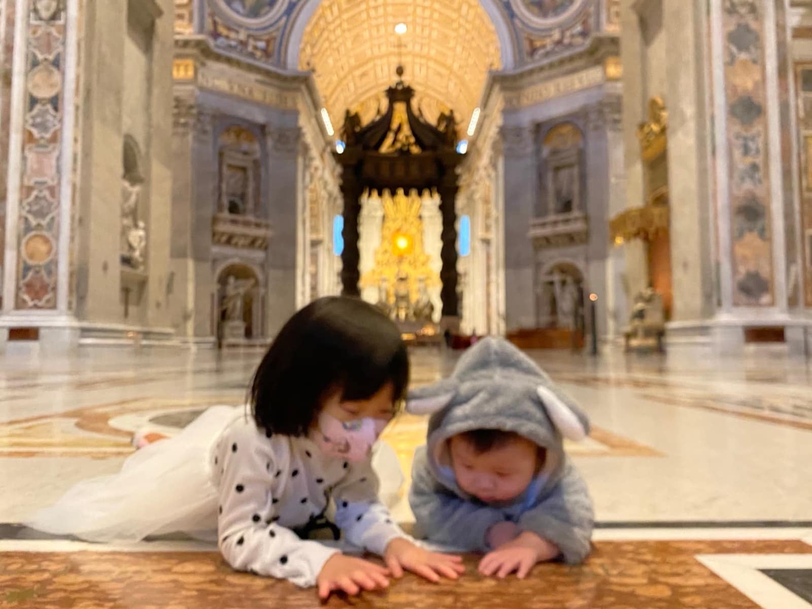 Sophie and George lying on the floor of the almost empty Vatican