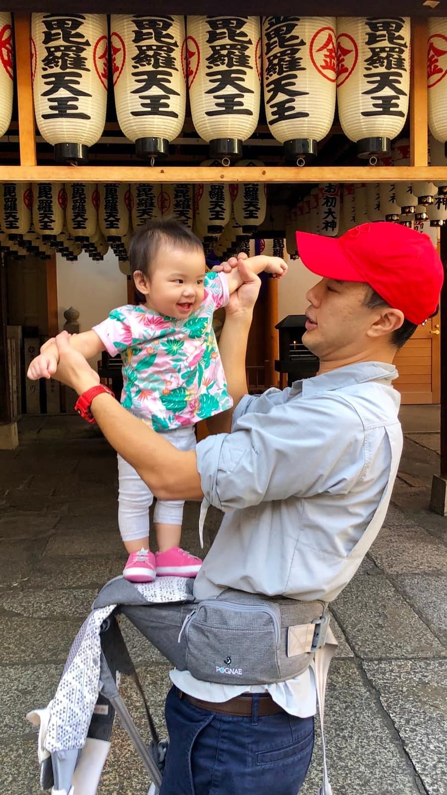 Philip carrying Sophie beneath lanterns in Dotonbori