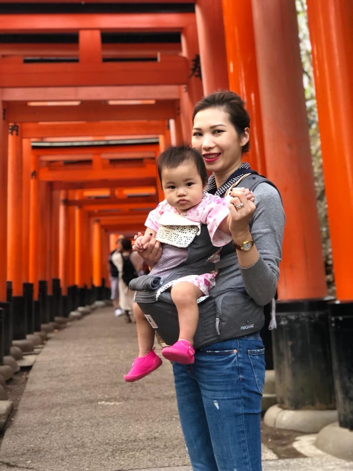 Vanessa carrying Sophie beneath the torii gates at Fushimi Inari