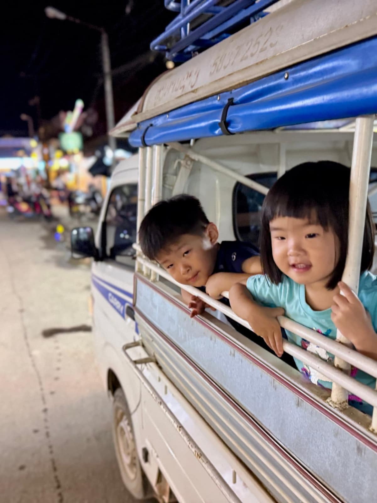 The children travelling in a local songthaew