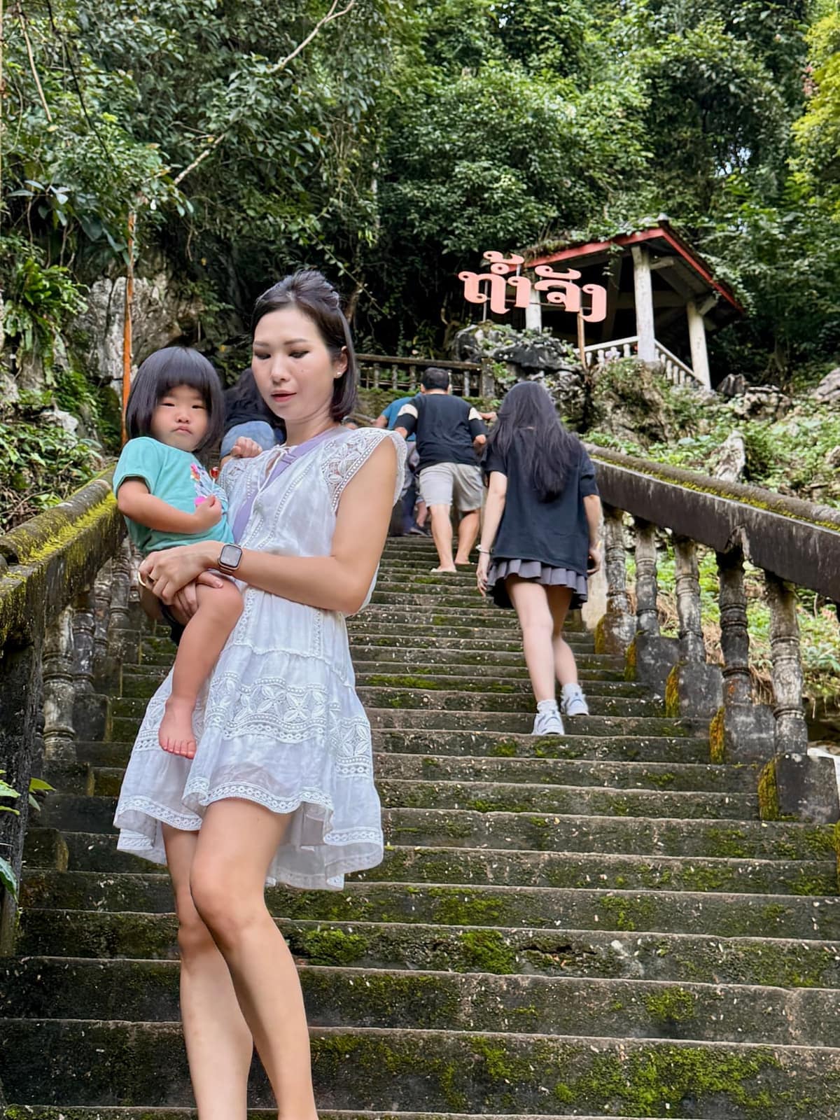The family walking towards Tham Phu Kham Cave