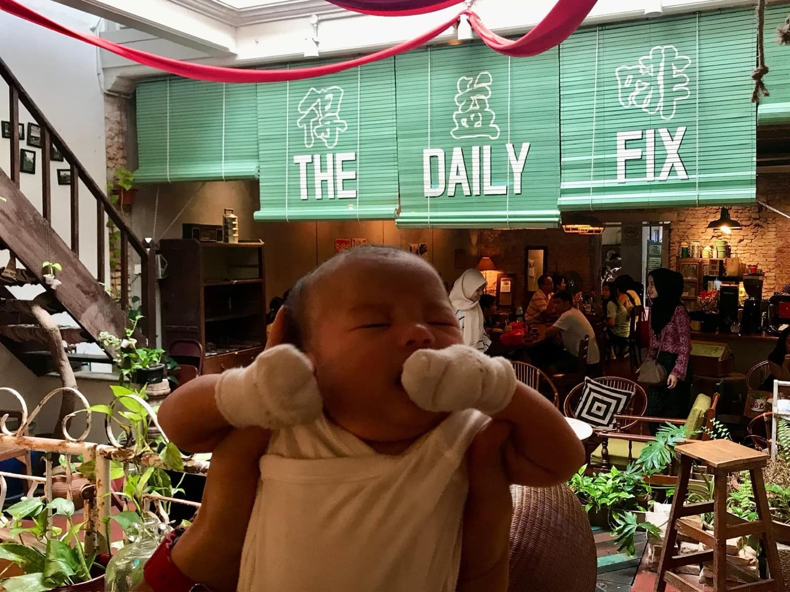 Baby Sophie being held up inside The Daily Fix in Malacca