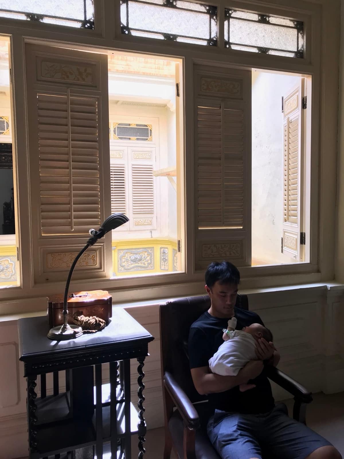 Philip bottle-feeding baby Sophie during the Malacca trip