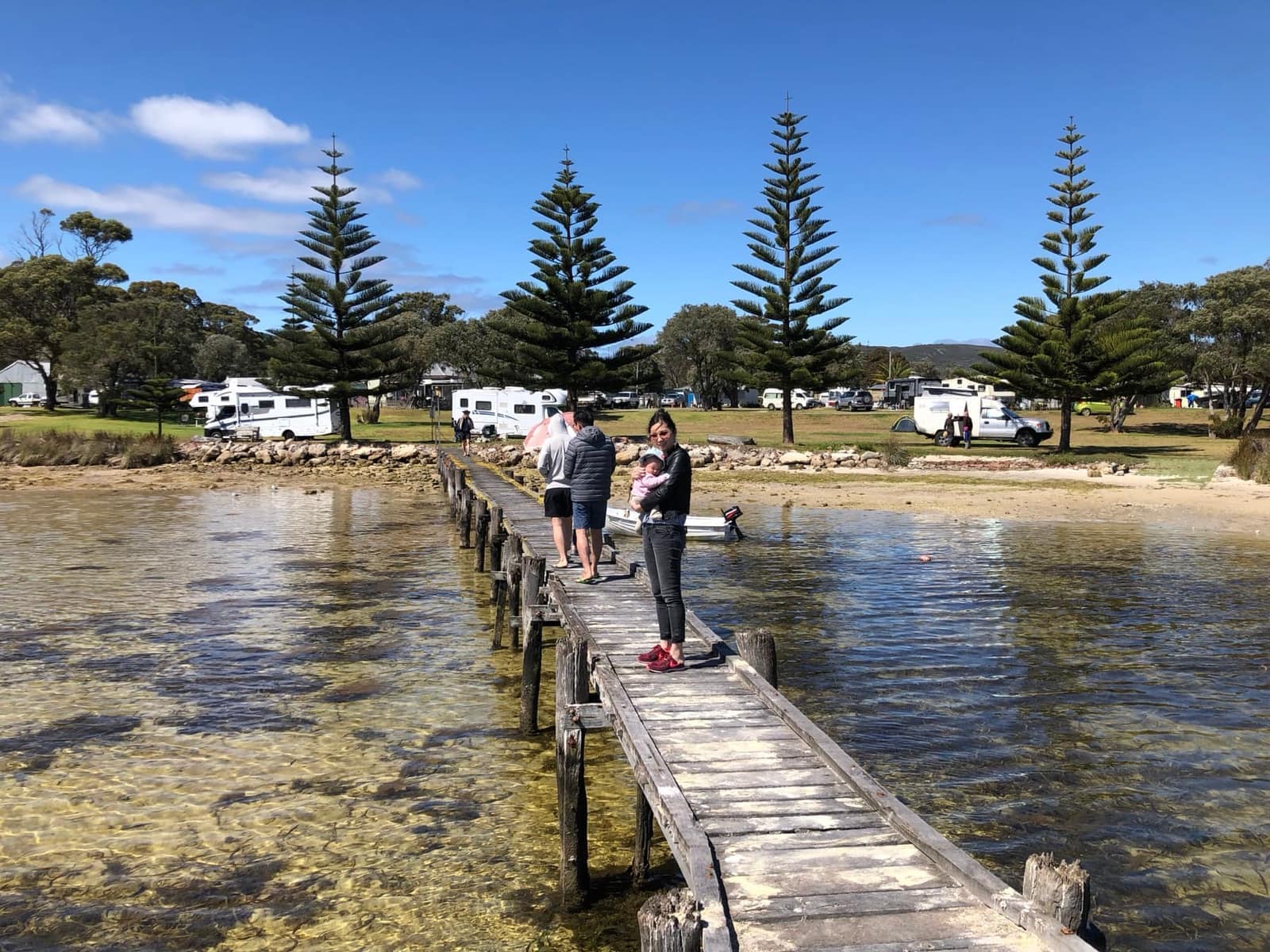 Family walking along a waterside boardwalk