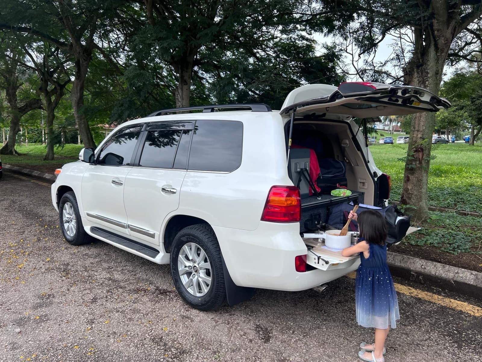 Sophie preparing lunch from the back of the Land Cruiser