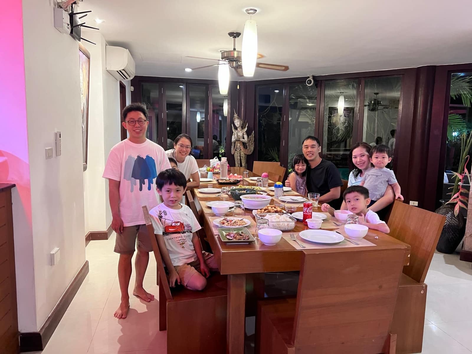 The family sharing a meal with friends in Phuket