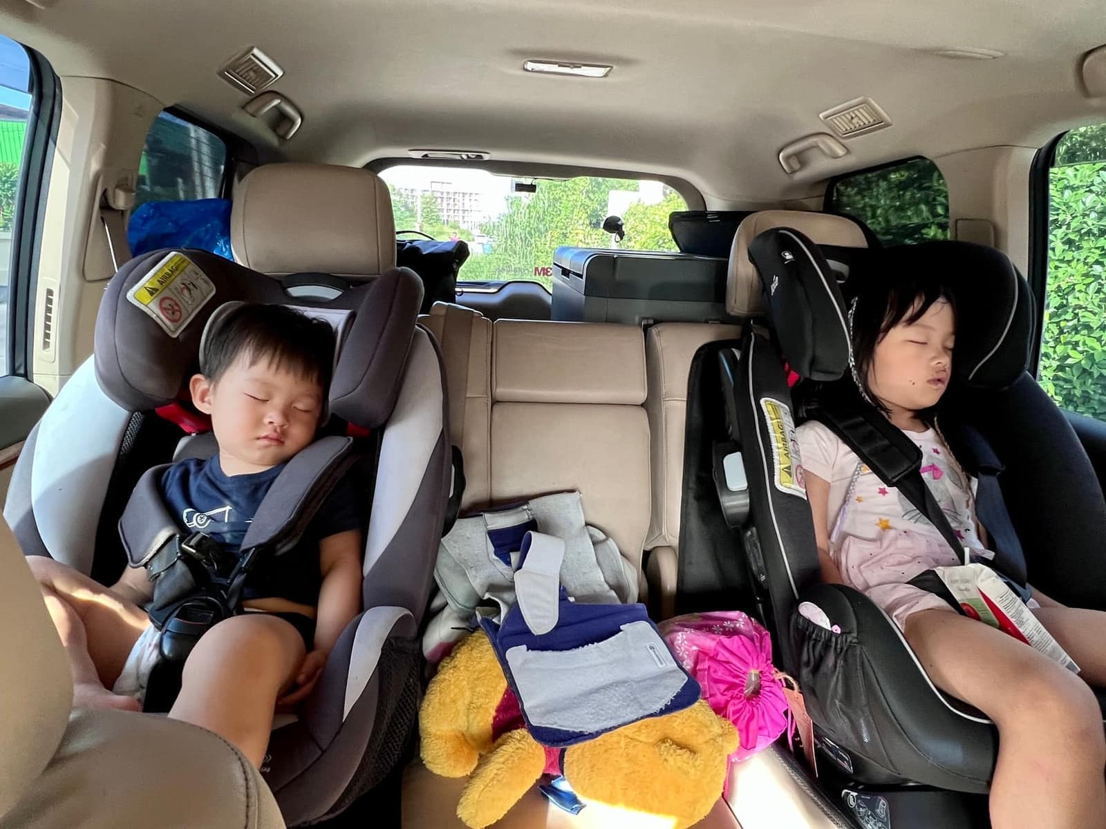 The children sleeping in their car seats during the long drive
