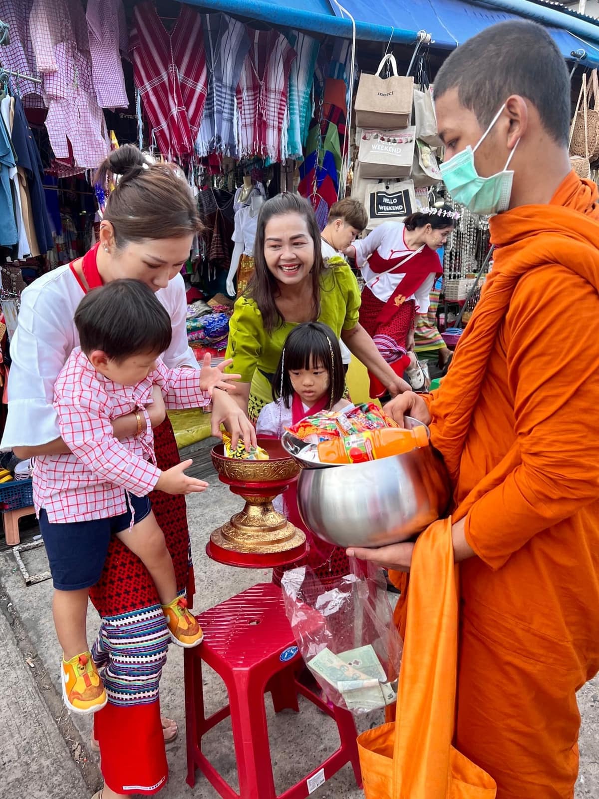 The family giving alms to monks at dawn