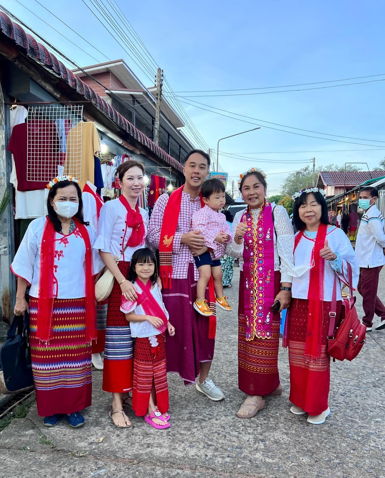 The family among people dressed for the morning at Sangkhla Buri