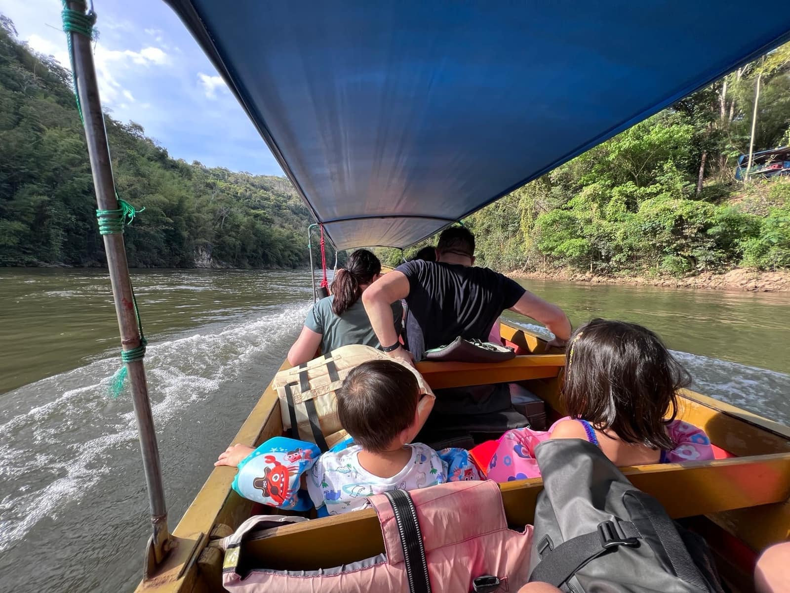 The children riding by longboat on the River Kwai