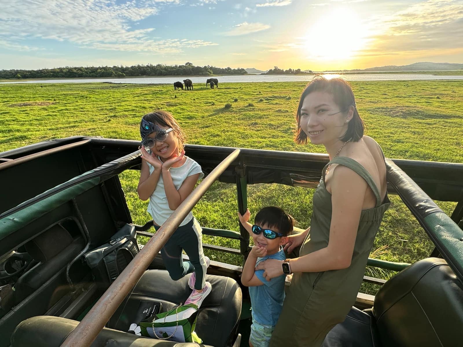 Vanessa and the children standing in an open safari jeep at sunrise