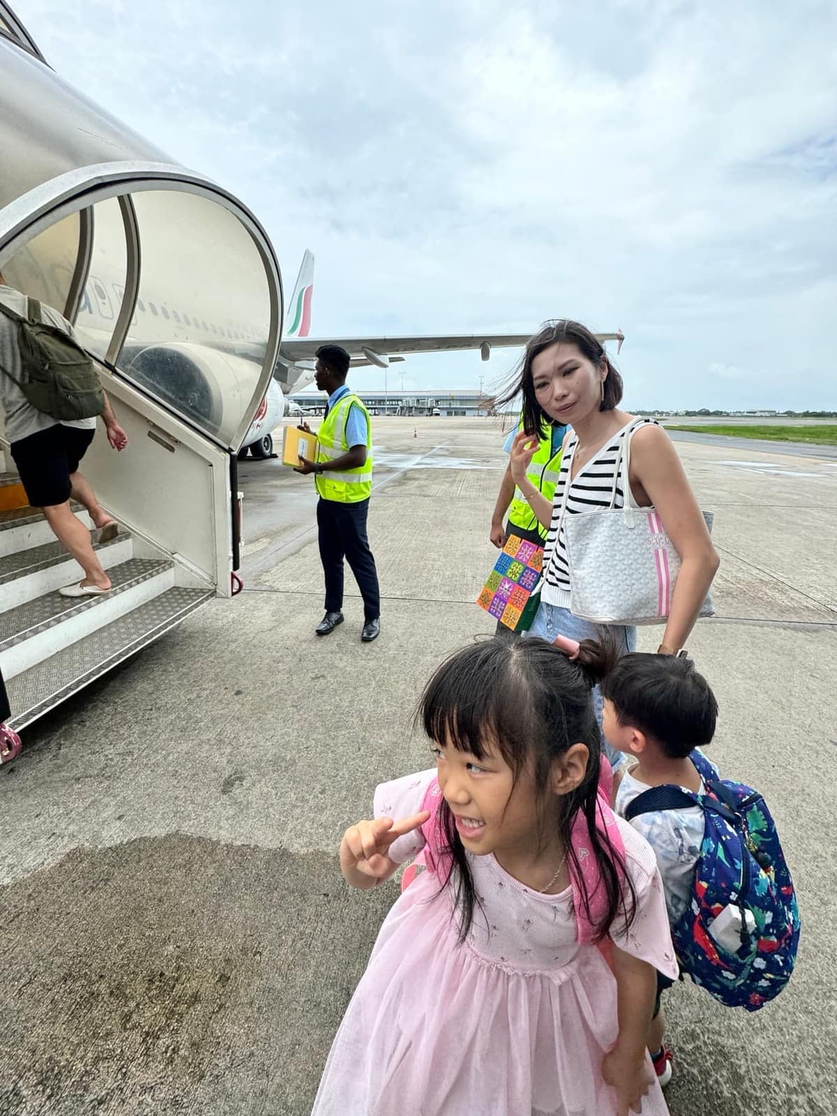 The family stepping away from an aircraft on arrival in the Maldives