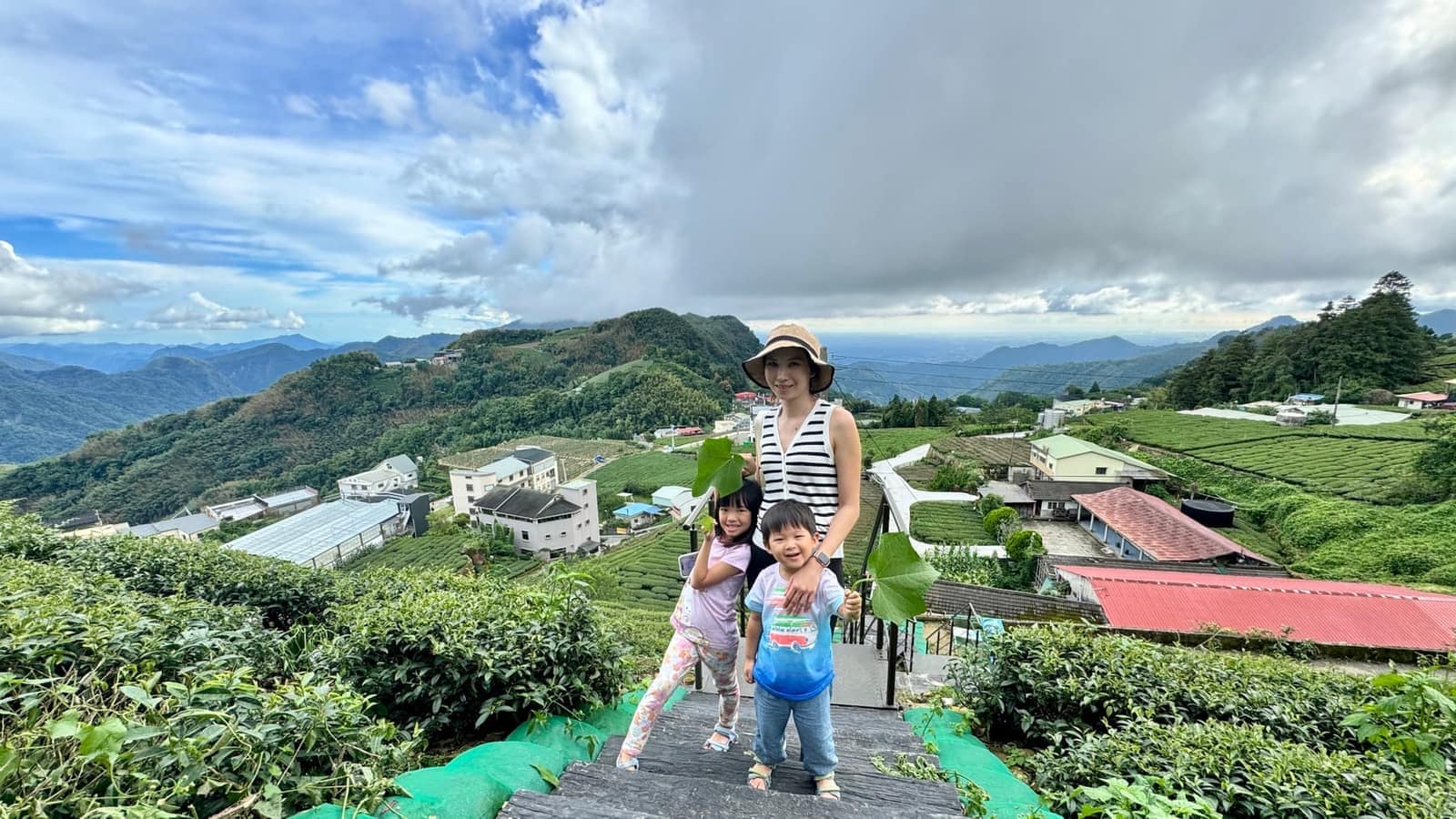 Vanessa and the children overlooking the tea-covered hills near Fenchihu