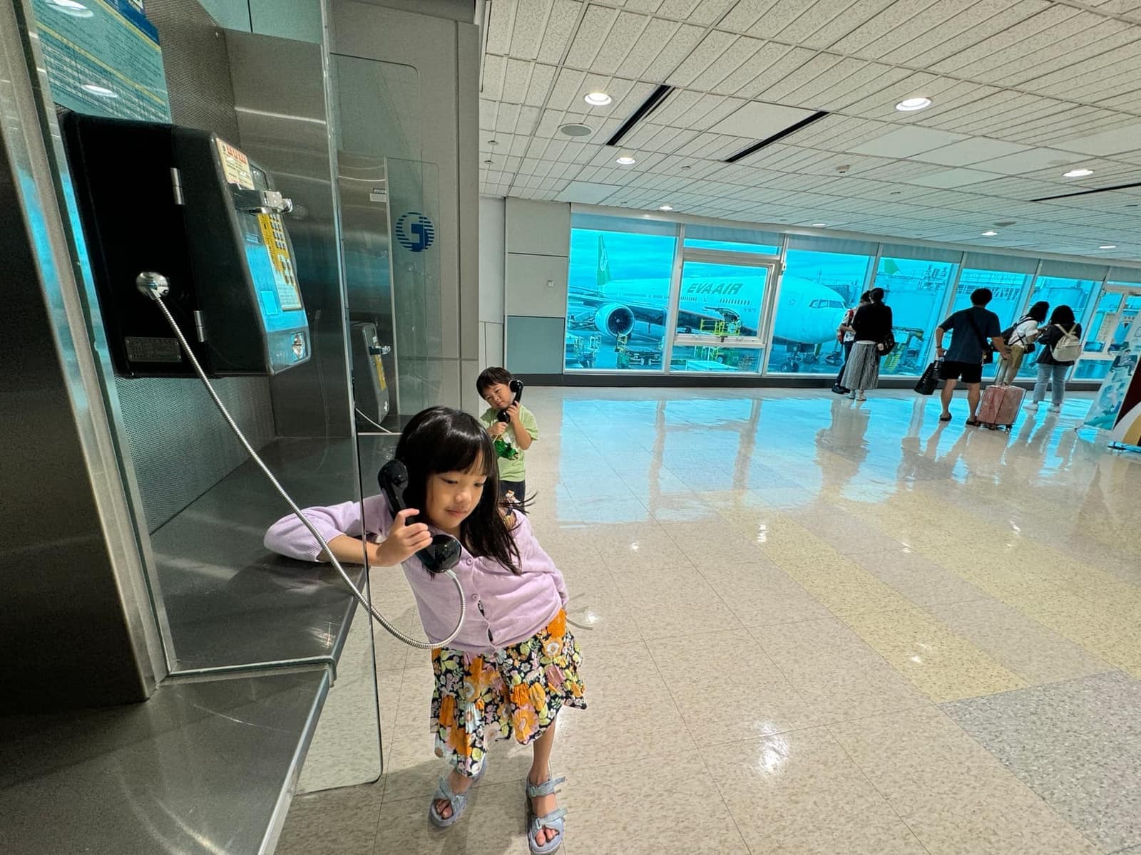 Sophie walking through Taoyuan Airport on the way home
