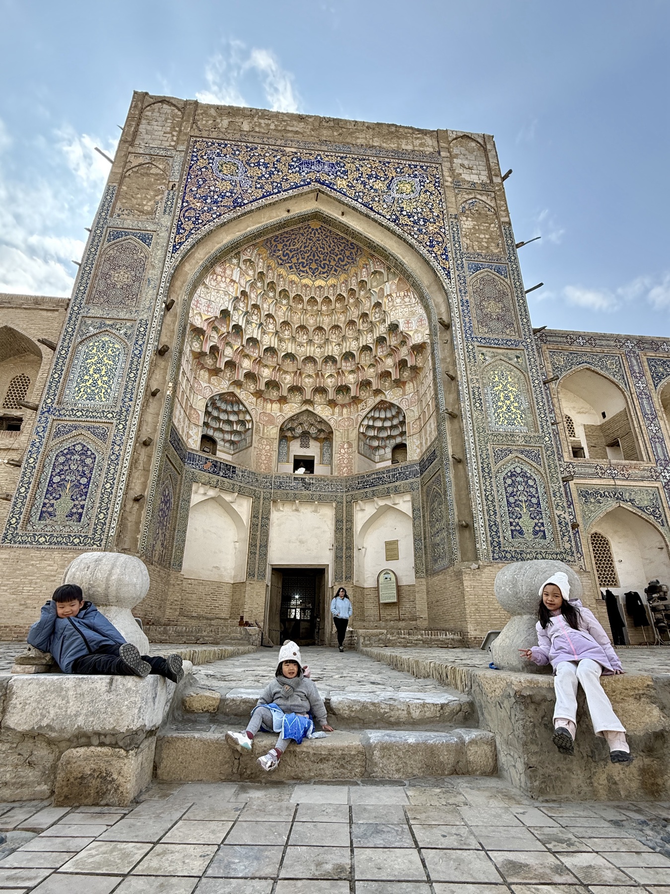Family at a historic monument in Bukhara